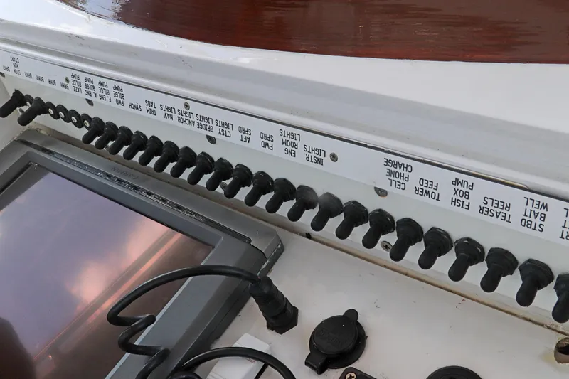 Slide: The Image of Control panel of a 1997 Gamefisherman 34 Express boat with labeled switches. - 18