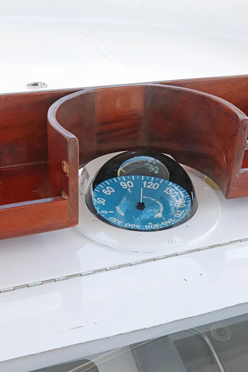 Slide: The Image of Compass on 1997 Gamefisherman 34 Express boat with wooden casing. - 19