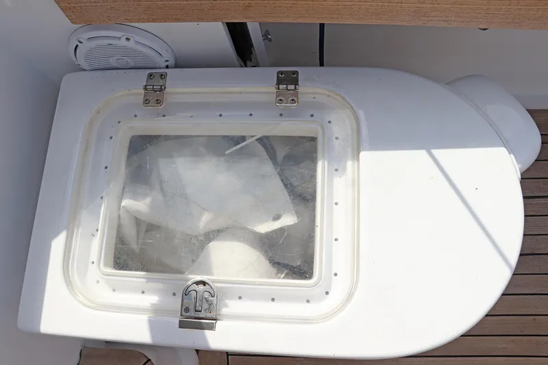 Slide: The Image of Hinged hatch on 1997 Gamefisherman 34 Express boat, featuring a transparent window. - 22