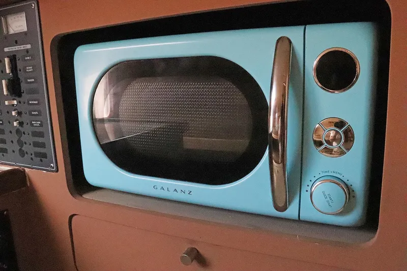 Slide: The Image of Retro blue Galanz microwave inside a 1997 Gamefisherman 34 Express boat. - 24