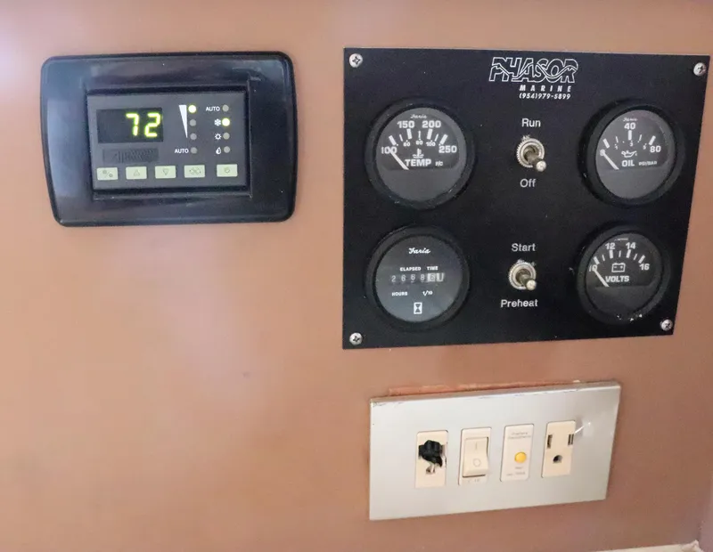 Slide: The Image of Control panel of a 1997 Gamefisherman 34 Express boat with gauges and switches. - 25