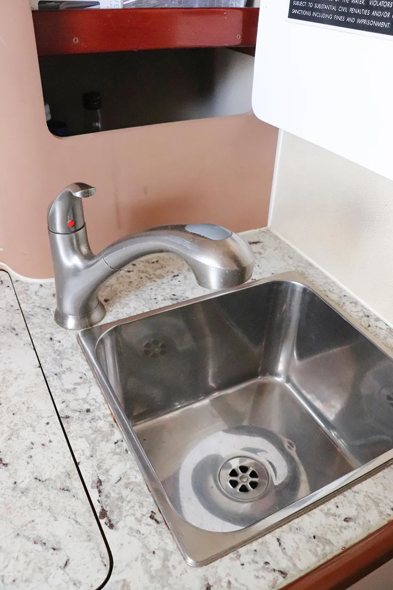 Slide: The Image of Stainless steel sink and faucet on a Gamefisherman 34 Express, 1997 model. - 26