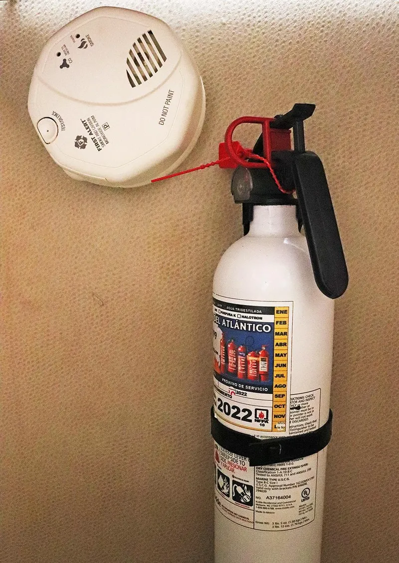 Slide: The Image of Fire extinguisher and smoke detector on Gamefisherman 34 Express, 1997 model. - 28