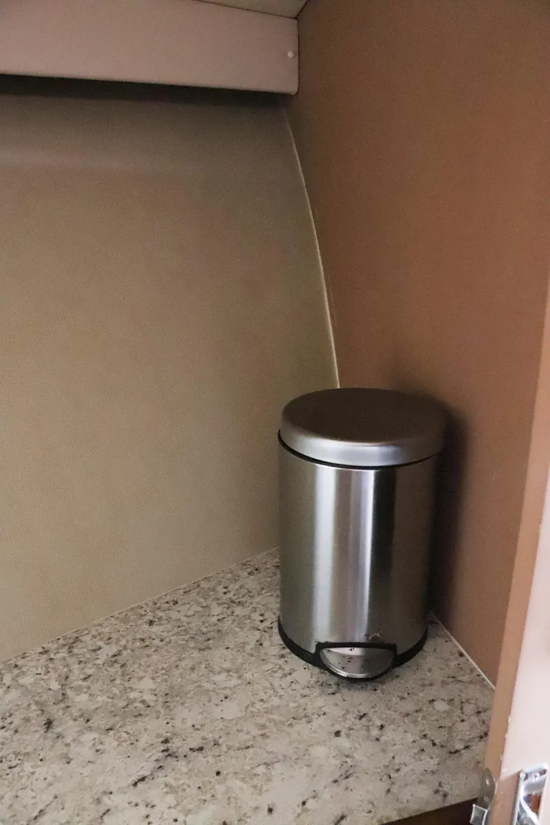 Slide: The Image of Stainless steel trash can on granite counter inside a 1997 Gamefisherman 34 Express boat. - 31