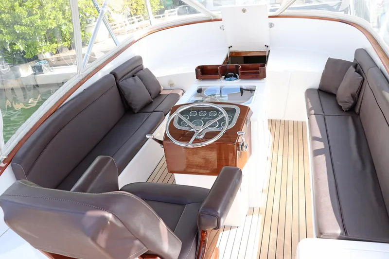 Slide: The Image of 1997 Gamefisherman 34 Express boat interior with wooden deck and cushioned seating. - 32