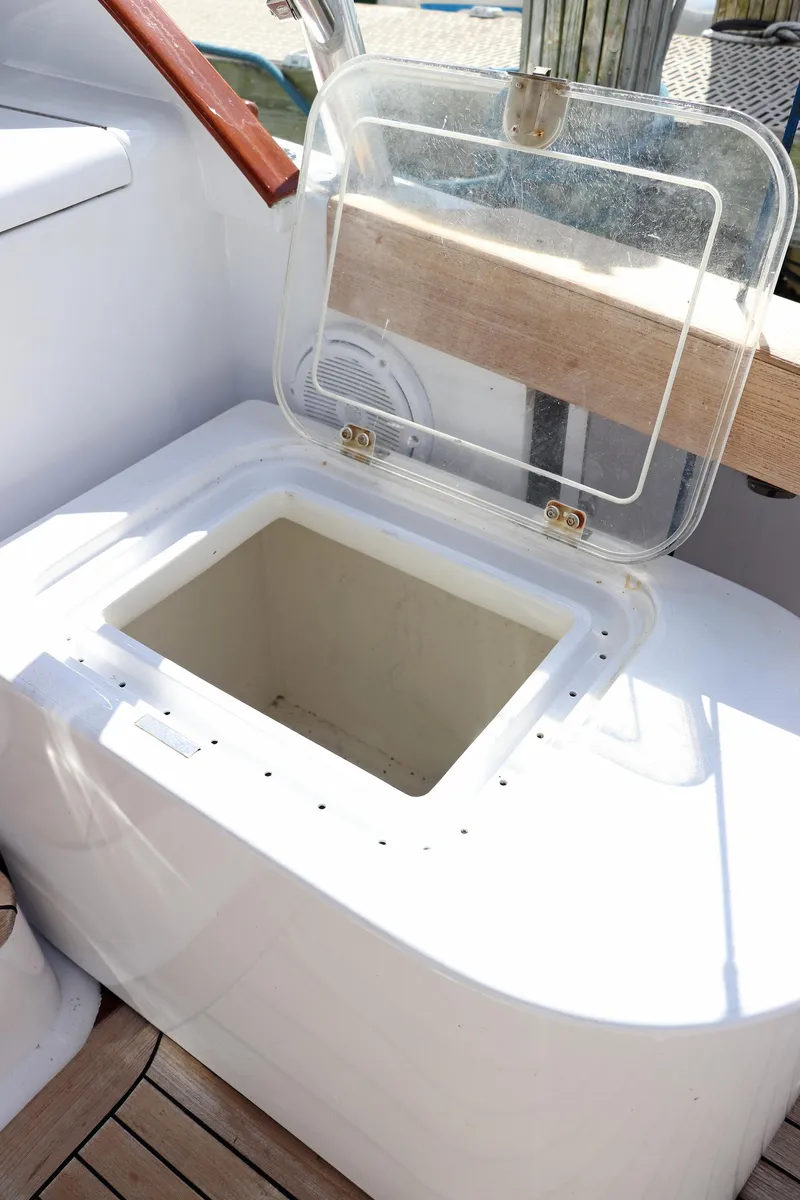 Slide: The Image of Open storage compartment on 1997 Gamefisherman 34 Express boat deck. - 33