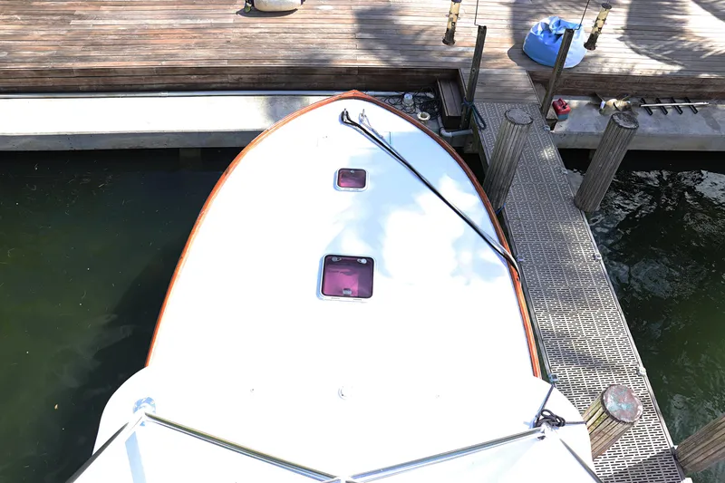 Slide: The Image of 1997 Gamefisherman 34 Express boat docked, top view showing deck and water. - 36