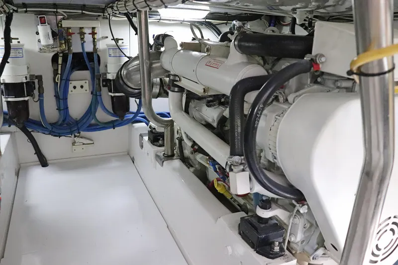 Slide: The Image of Engine room of 1997 Gamefisherman 34 Express, showcasing mechanical components and piping. - 37