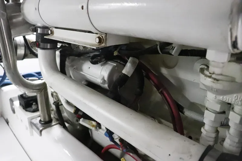 Slide: The Image of Engine compartment of 1997 Gamefisherman 34 Express boat, showcasing pipes and wiring. - 40