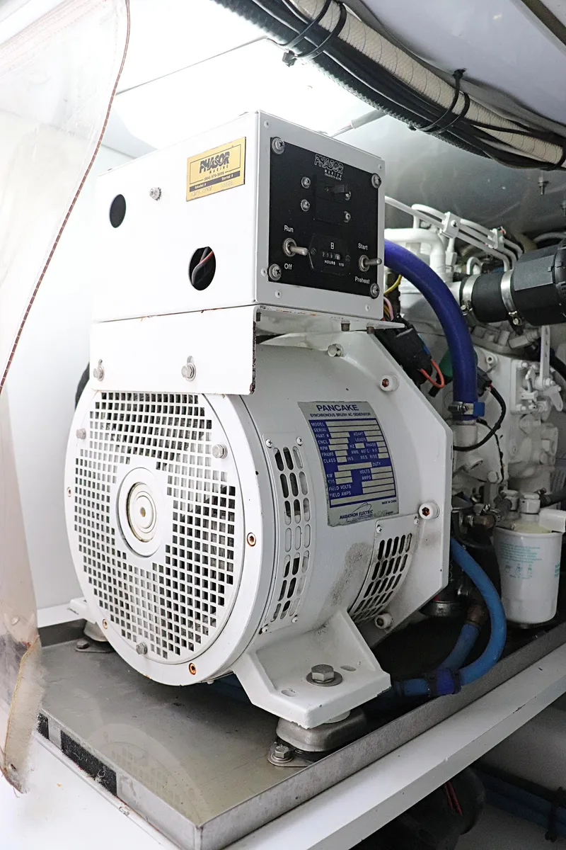 Slide: The Image of Engine room of 1997 Gamefisherman 34 Express, featuring a white marine generator. - 43