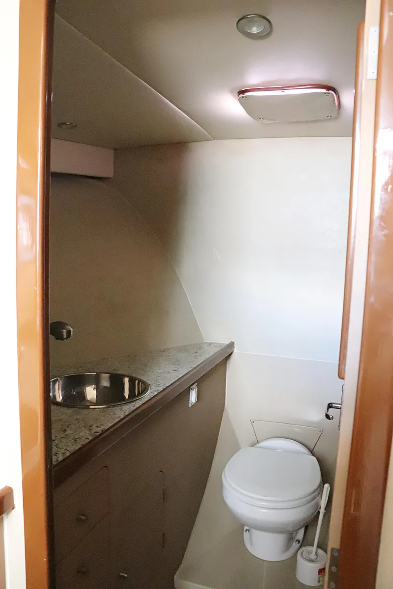 Slide: The Image of 1997 Gamefisherman 34 Express boat bathroom with sink and toilet. - 48