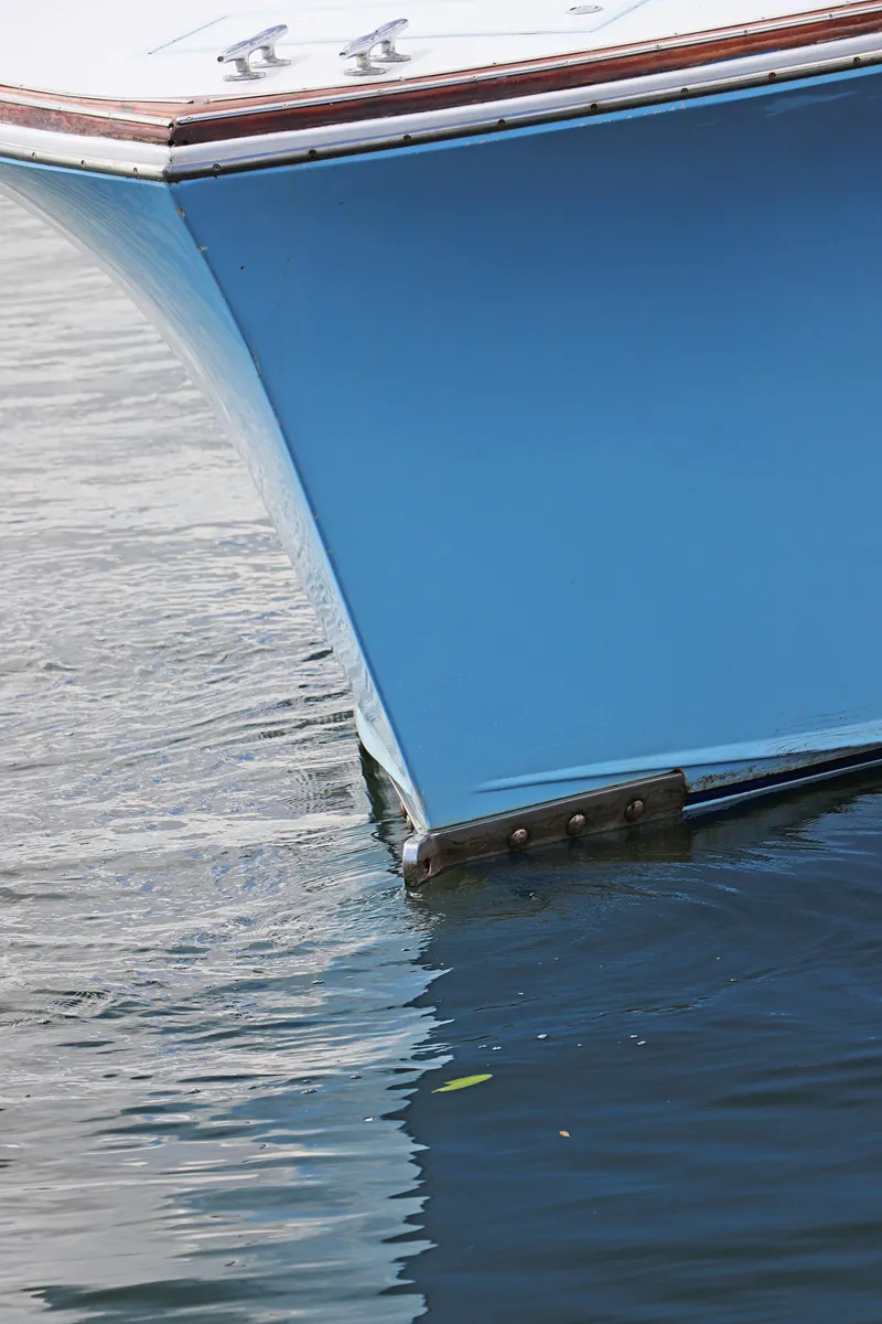 Slide: The Image of Close-up of a 1997 Gamefisherman 34 Express boat hull in water. - 7