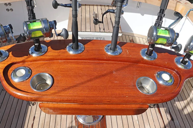 Slide: The Image of Fishing rods on Gamefisherman 34 Express 1997 boat with wooden deck and holders. - 9