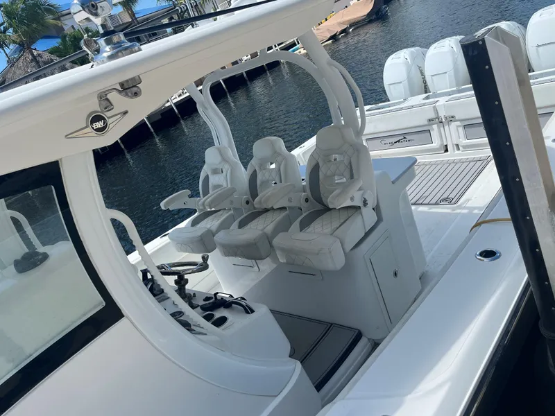 Slide: The Image of Luxury Blackwater 43 boat interior, 2018 model, featuring sleek white seating and modern design. - 11