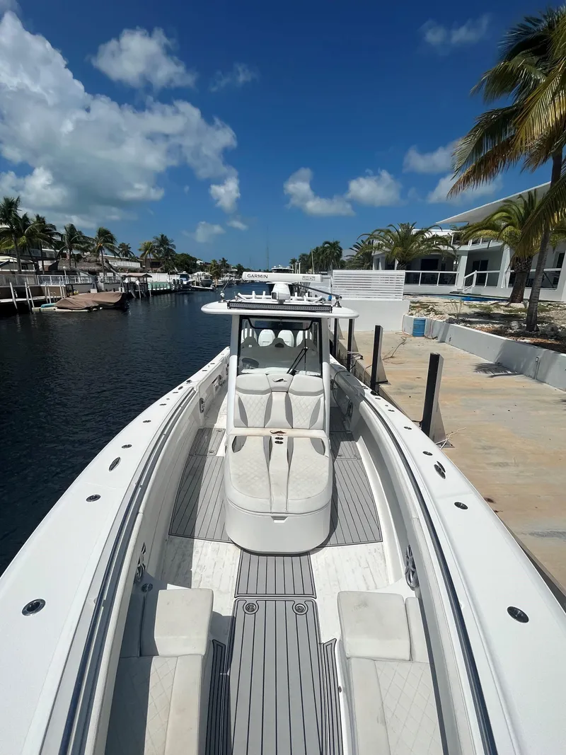 Slide: The Image of 2018 Blackwater 43 boat docked by palm trees under a clear blue sky. - 14