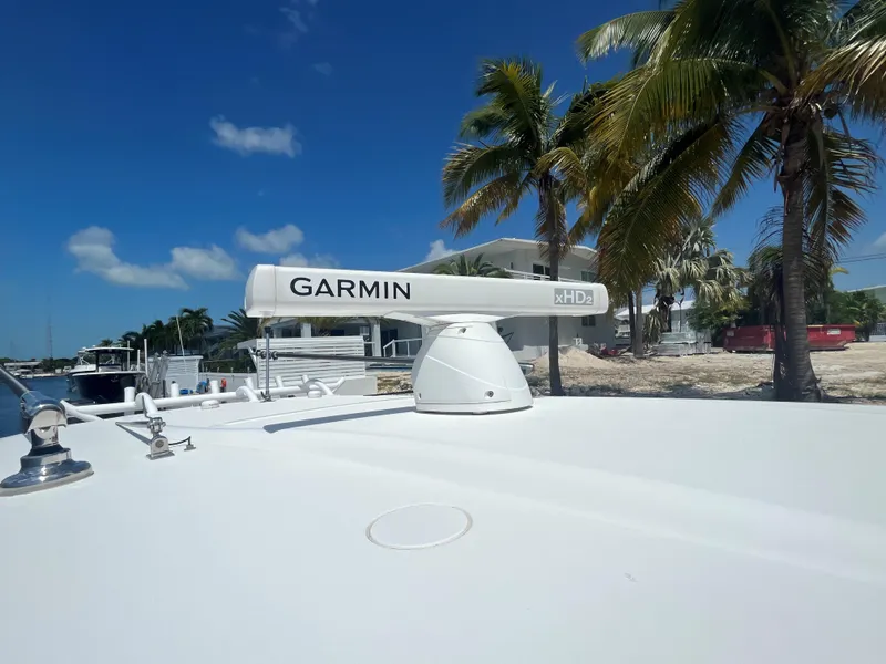 Slide: The Image of Garmin radar on 2018 Blackwater 43 boat, with palm trees and blue sky background. - 16
