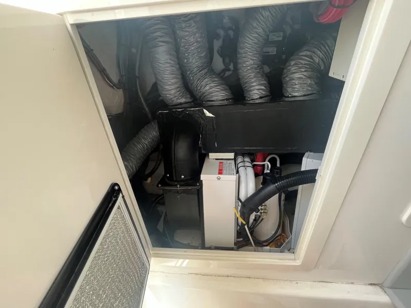 Slide: The Image of Engine compartment of a 2018 Blackwater 43 boat, showing mechanical components and wiring. - 21