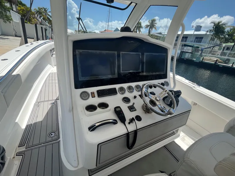 Slide: The Image of Cockpit of 2018 Blackwater 43 boat with dual screens and steering wheel. - 31