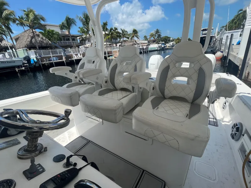 Slide: The Image of Luxury seating on a 2018 Blackwater 43 boat, docked by a scenic waterfront. - 32