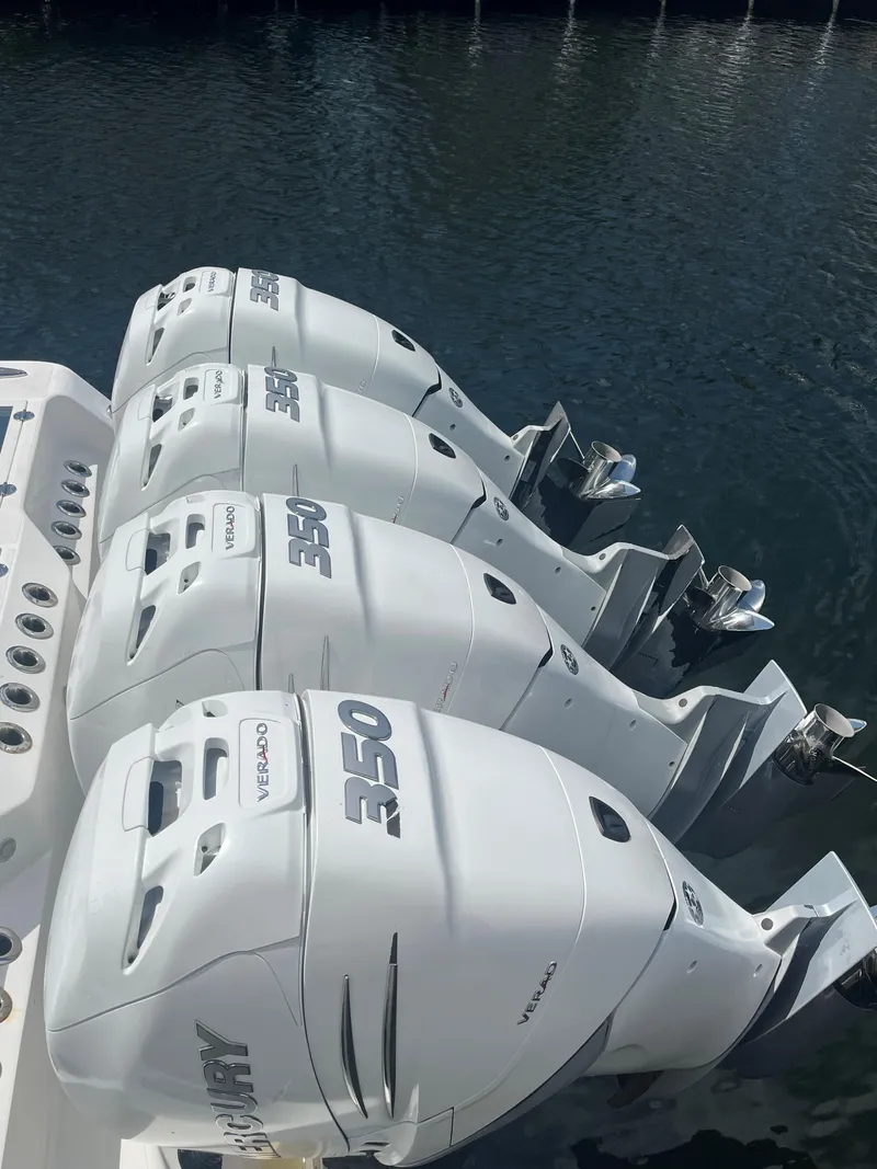 Slide: The Image of Four powerful outboard engines on a 2018 Blackwater 43 boat, docked on calm water. - 6