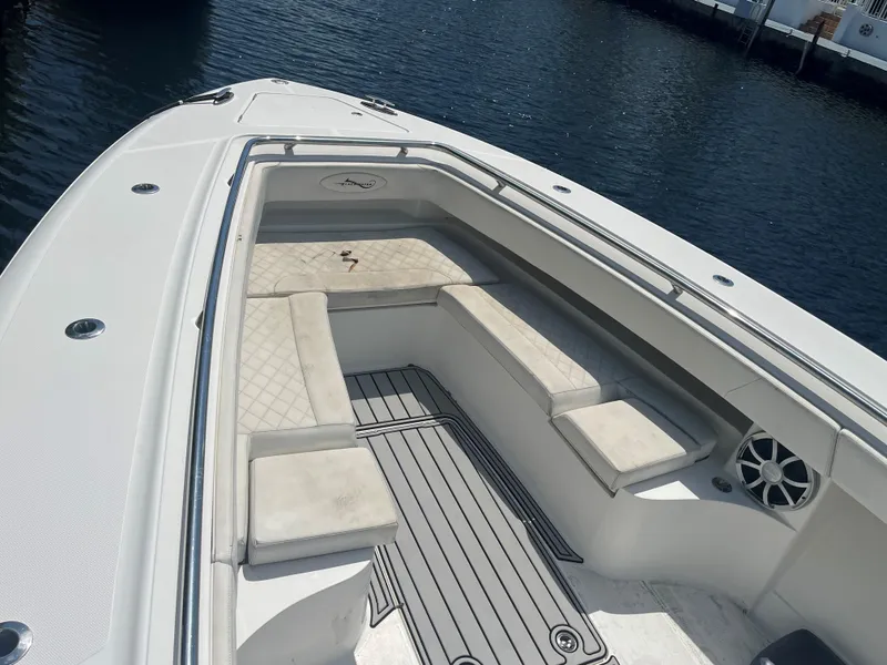 Slide: The Image of 2018 Blackwater 43 boat with cushioned seating, docked on calm water. - 7
