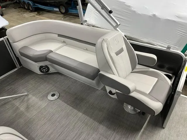 Slide: The Image of 2022 Sweetwater 2286SBCX boat interior with gray seating and modern design. - 2