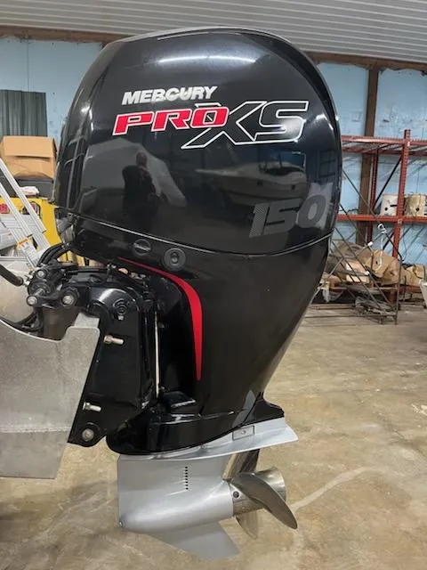 Slide: The Image of 2022 Sweetwater 2286SBCX with Mercury Pro XS outboard motor in a workshop setting. - 8