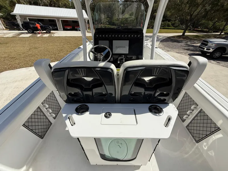 Slide: The Image of 2021 Wellcraft 242 Offshore boat interior with dual seats and Garmin navigation system. - 11