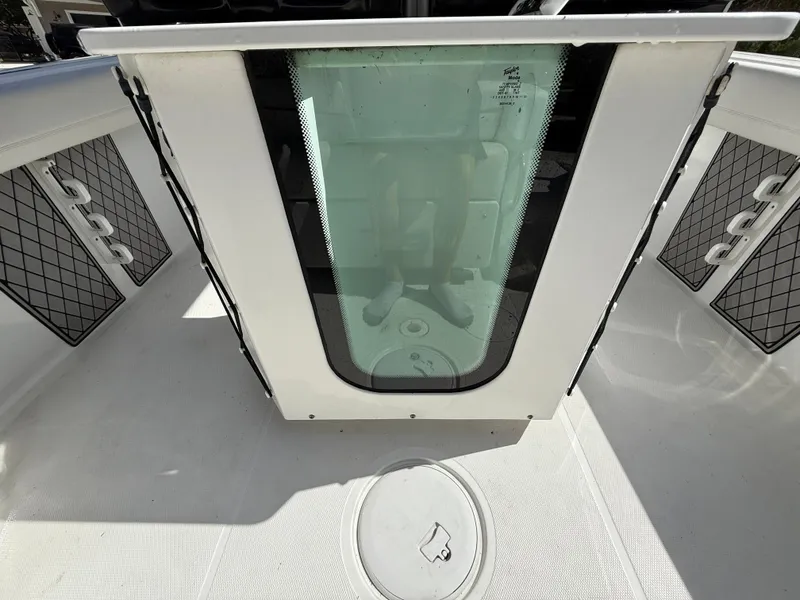 Slide: The Image of 2021 Wellcraft 242 Offshore boat interior with storage compartments and seating area. - 13