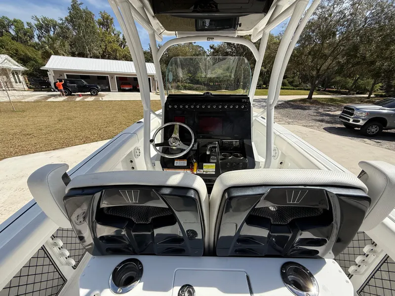 Slide: The Image of 2021 Wellcraft 242 Offshore boat interior with dual seats and steering console. - 15