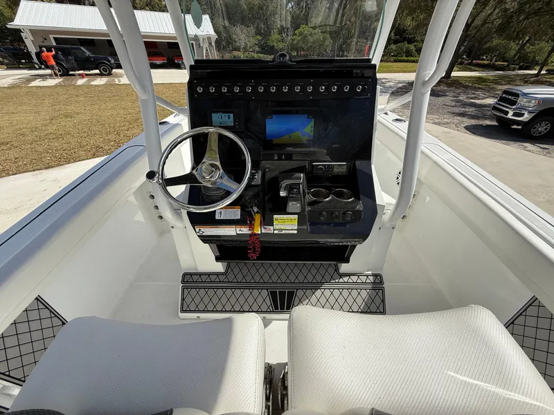 Slide: The Image of 2021 Wellcraft 242 Offshore boat cockpit with steering wheel and control panel. - 16