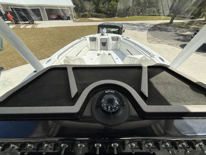 Slide: The Image of 2021 Wellcraft 242 Offshore boat interior with compass and control panel. - 18