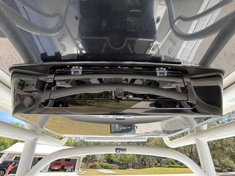 Slide: The Image of 2021 Wellcraft 242 Offshore boat interior, showcasing overhead storage compartment and sleek design. - 22