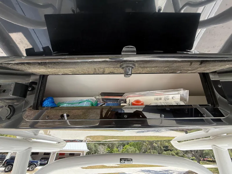 Slide: The Image of Storage compartment of a 2021 Wellcraft 242 Offshore boat, containing various items. - 23