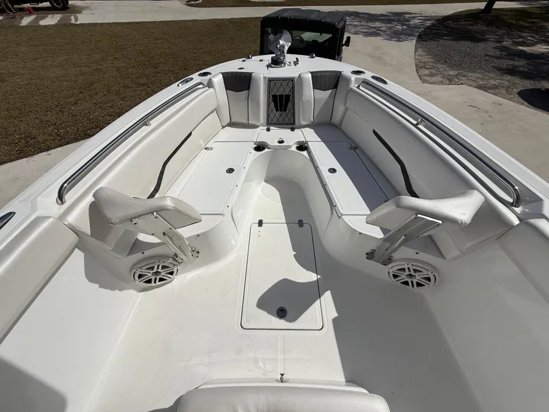 Slide: The Image of 2021 Wellcraft 242 Offshore boat interior with white seating and spacious deck layout. - 24