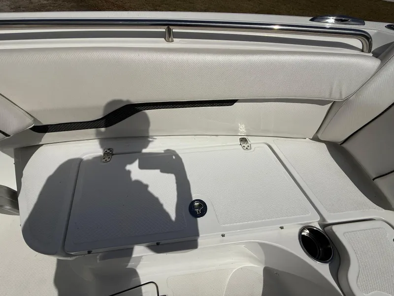 Slide: The Image of 2021 Wellcraft 242 Offshore boat interior with white seating and storage compartment. - 28