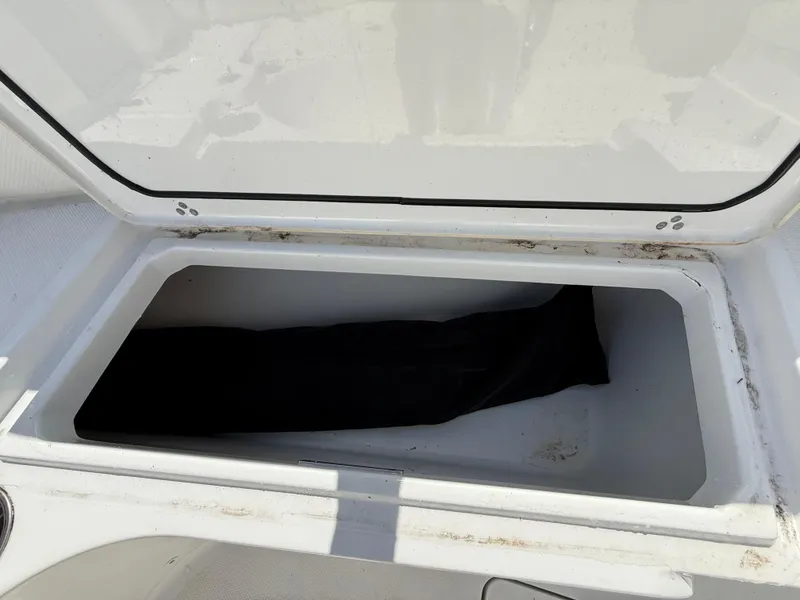 Slide: The Image of Open storage compartment on a 2021 Wellcraft 242 Offshore boat. - 31