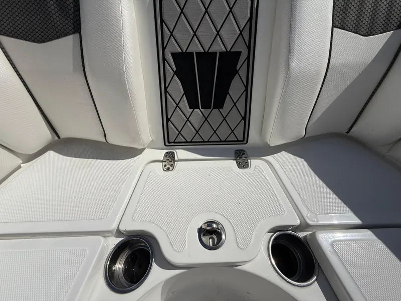 Slide: The Image of 2021 Wellcraft 242 Offshore boat interior with white textured seating and cup holders. - 32