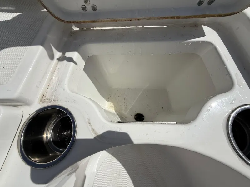 Slide: The Image of 2021 Wellcraft 242 Offshore boat storage compartment with cup holders. - 33