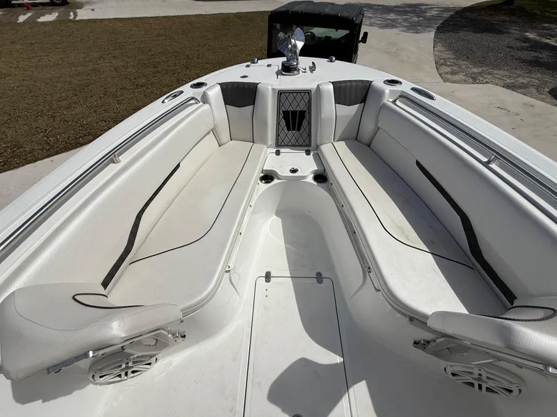 Slide: The Image of 2021 Wellcraft 242 Offshore boat interior with white seating and spacious layout. - 34