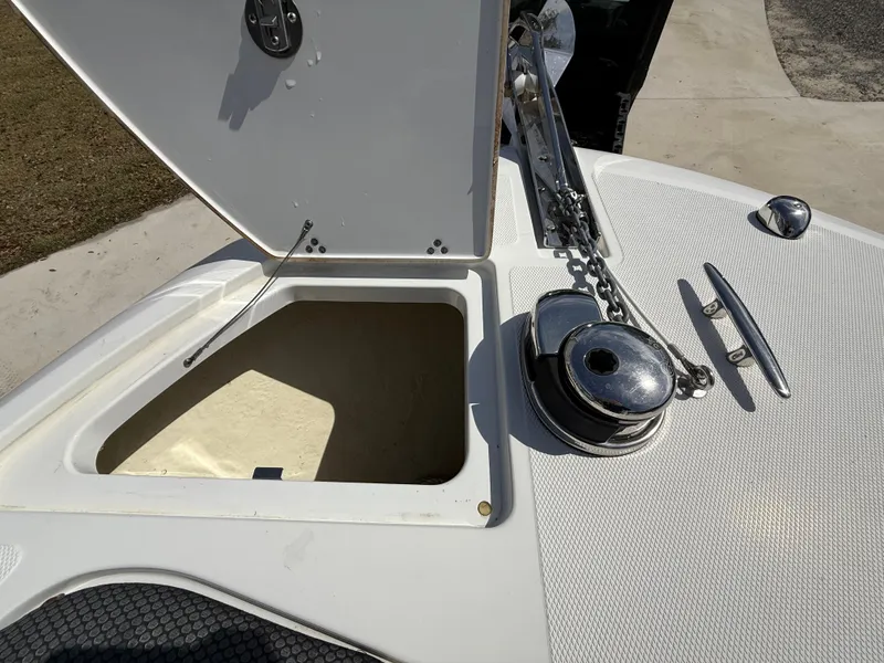 Slide: The Image of Open anchor locker on 2021 Wellcraft 242 Offshore boat, showing chain and cleat. - 36