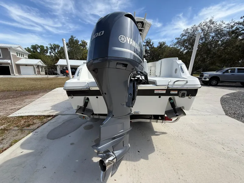 Slide: The Image of 2021 Wellcraft 242 Offshore boat with Yamaha outboard motor, parked on driveway. - 4