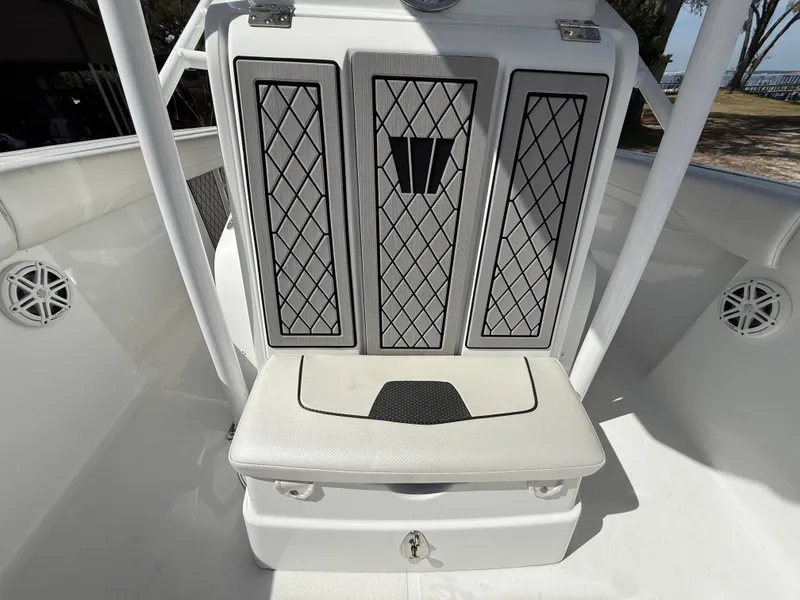 Slide: The Image of 2021 Wellcraft 242 Offshore boat interior with cushioned seating and storage. - 43