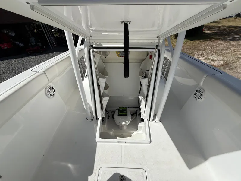 Slide: The Image of 2021 Wellcraft 242 Offshore boat interior with open cabin and seating area. - 44
