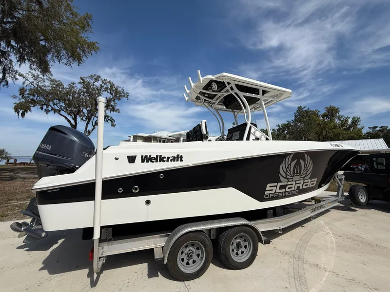 Slide: The Image of 2021 Wellcraft 242 Offshore boat on trailer, featuring Scarab Offshore branding. - 6