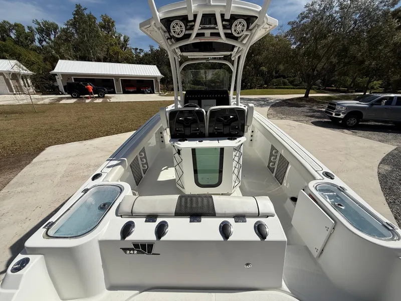 Slide: The Image of 2021 Wellcraft 242 Offshore boat interior, featuring spacious seating and modern amenities. - 9