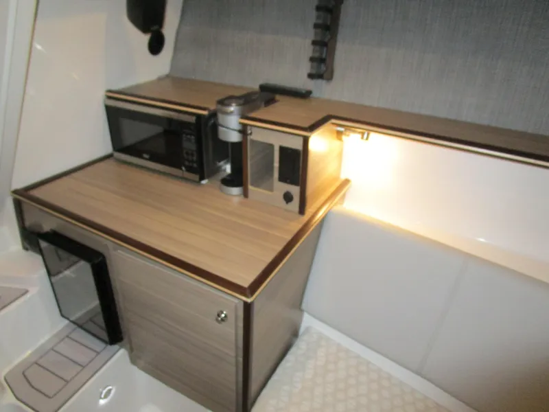 Slide: The Image of 2025 Solara S-310 CW boat interior with white and red-trimmed seating. - 21