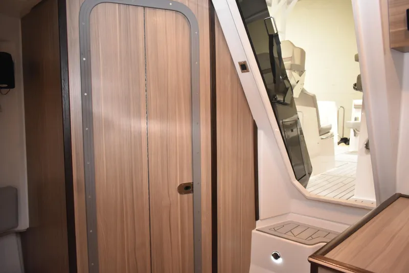 Slide: The Image of Showerhead in Solara S-310 CW yacht bathroom, 2025 model, with wood paneling and skylight. - 40