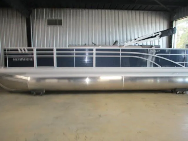 The Image of 2025 Bennington 23SXFAPG pontoon boat in a storage facility. - 1