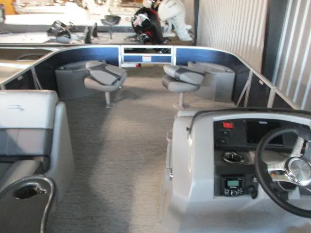 Slide: The Image of 2025 Bennington 23SXFAPG boat interior with seating and steering console. - 5